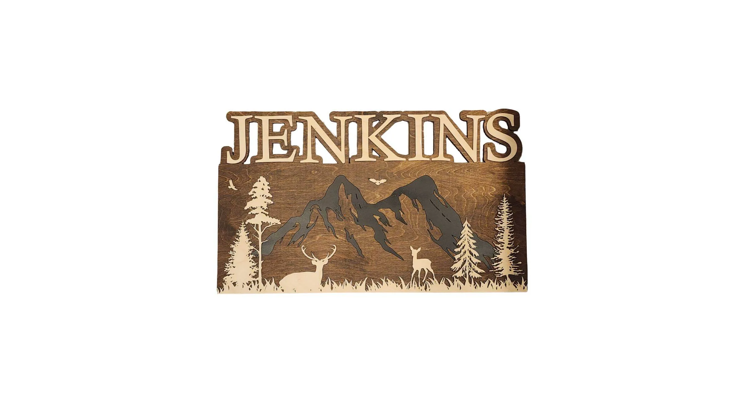 A rustic name sign featuring a forest scene